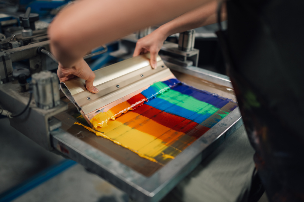 Person working with ink colors at screenprinting